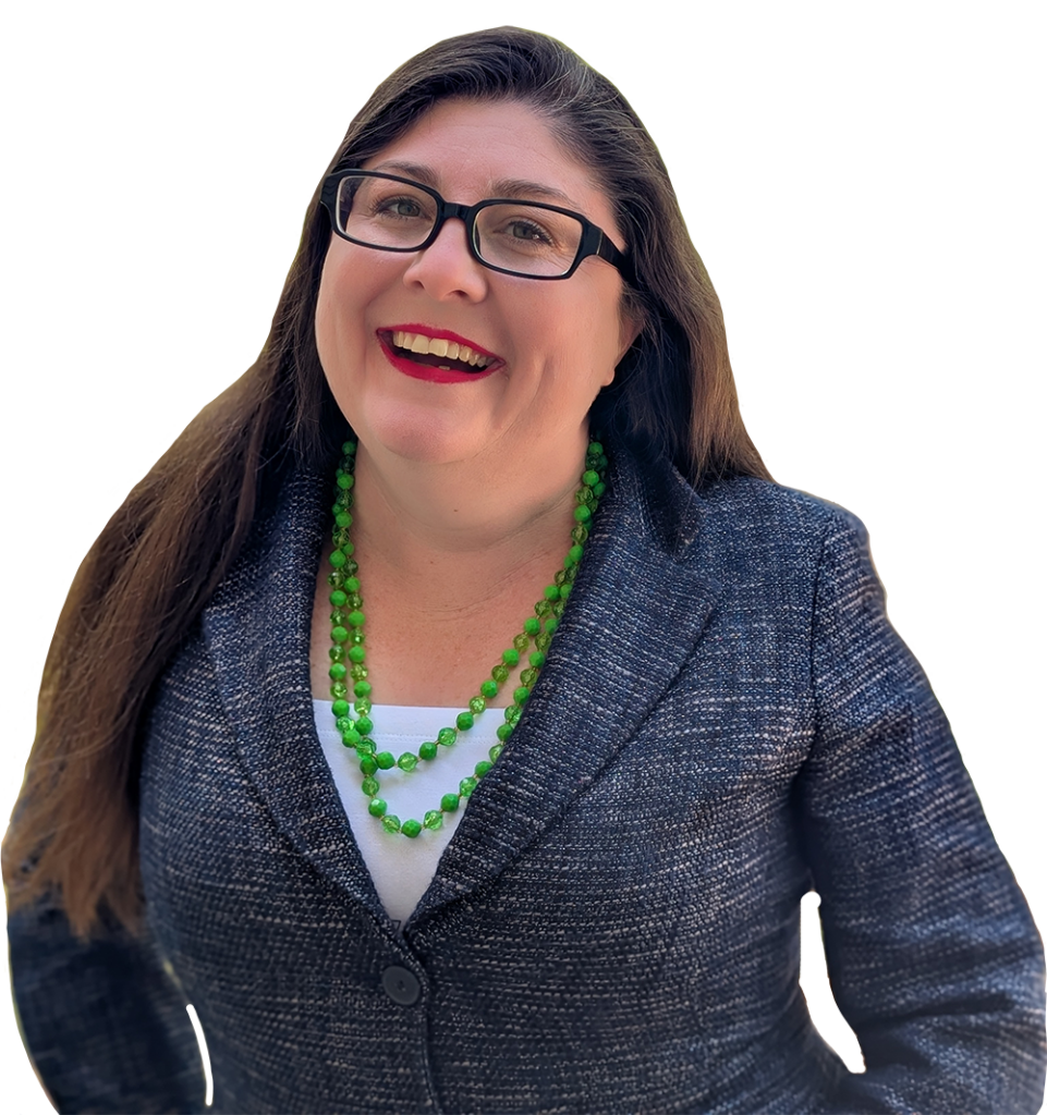 Shannon wearing a blue suit jacket and green necklace